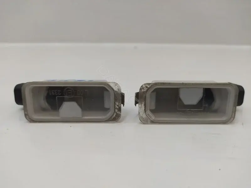 Фонарь подсветки номерного знака 7S7113550AB