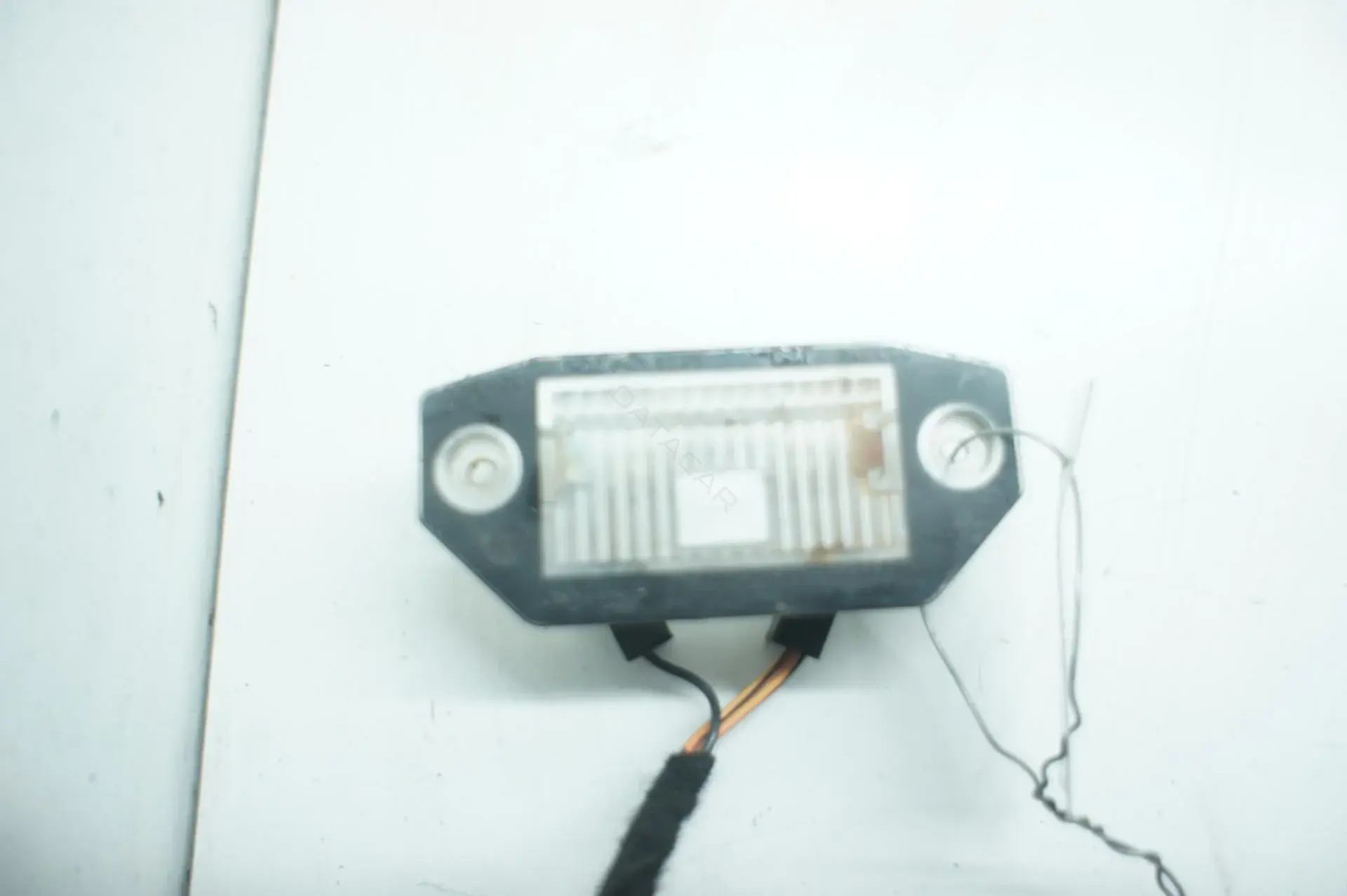 Фонарь подсветки номерного знака 1S7113550AC