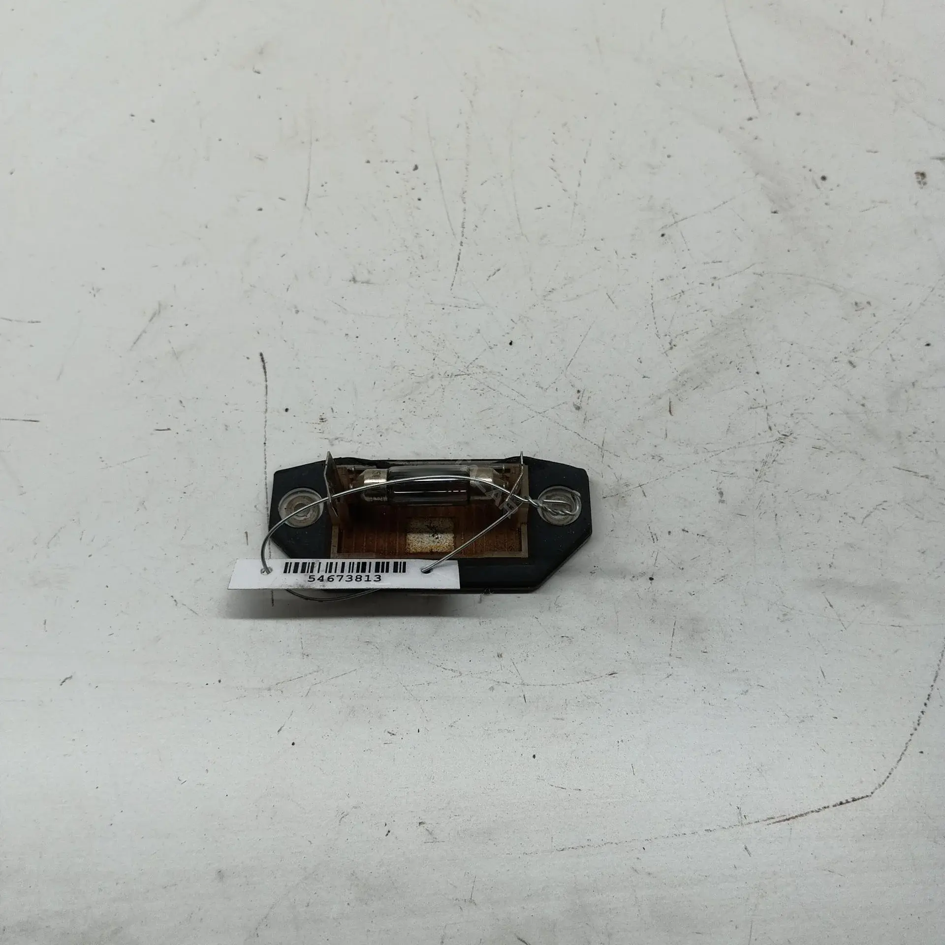 Фонарь подсветки номерного знака 1S7113550AC