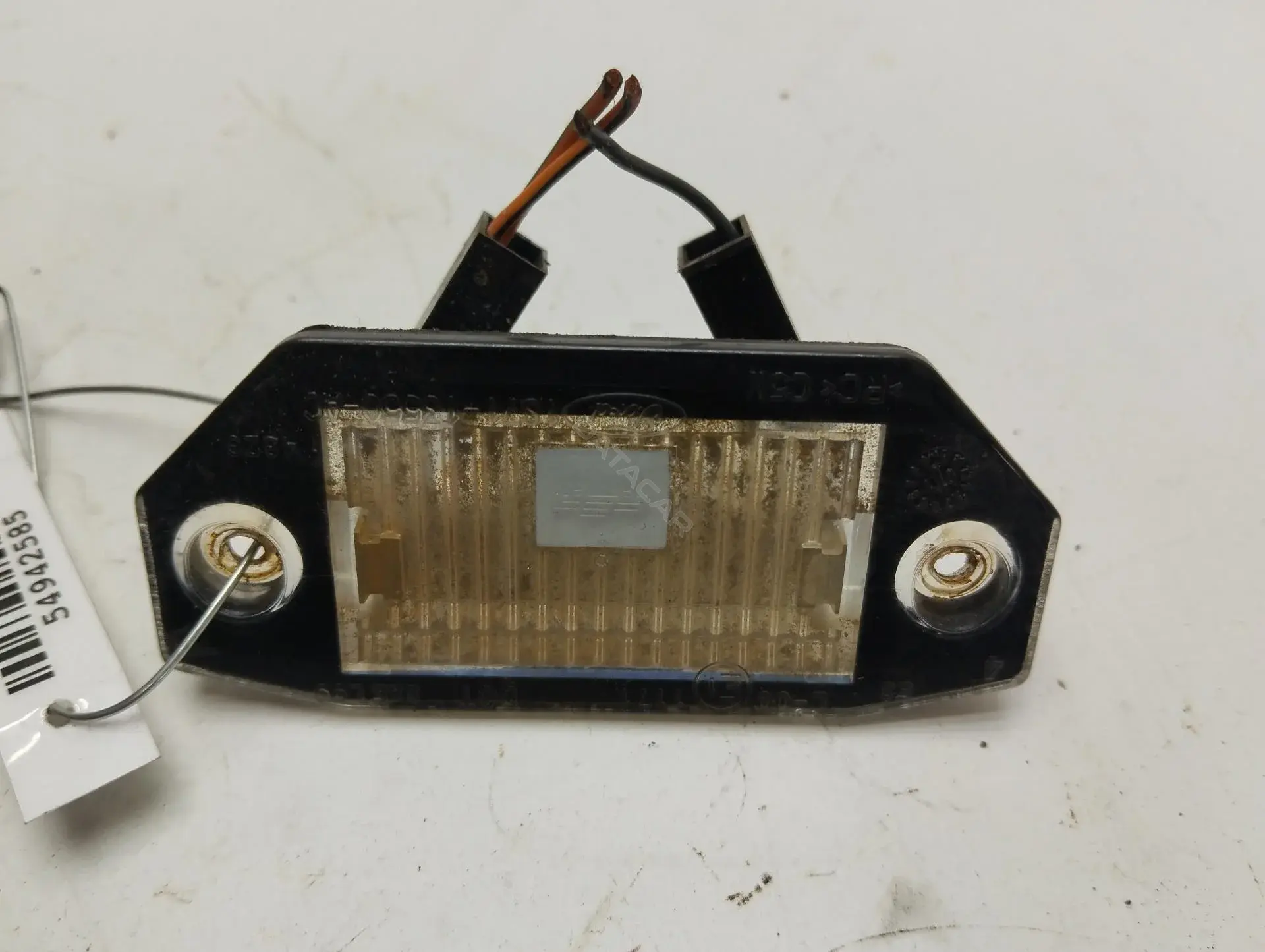 Фонарь подсветки номерного знака 1S7113550AC