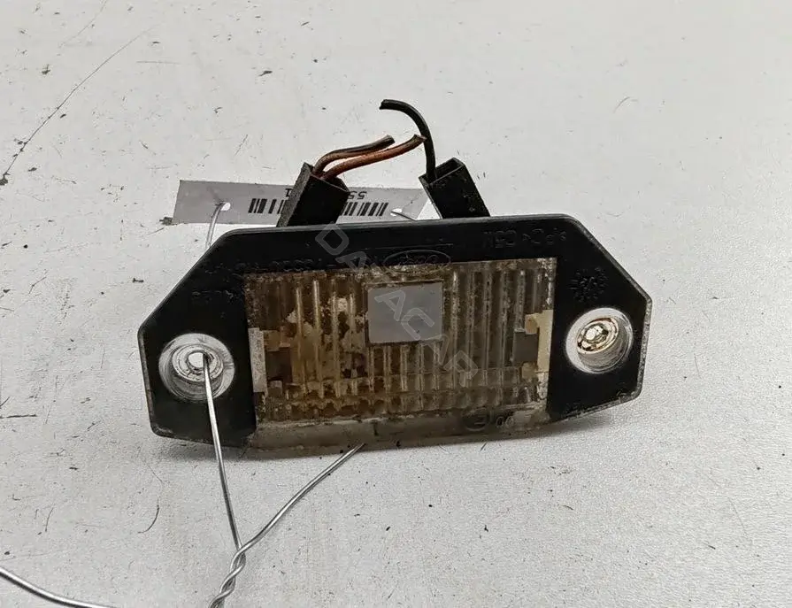 Фонарь подсветки номерного знака 1S7113550AC