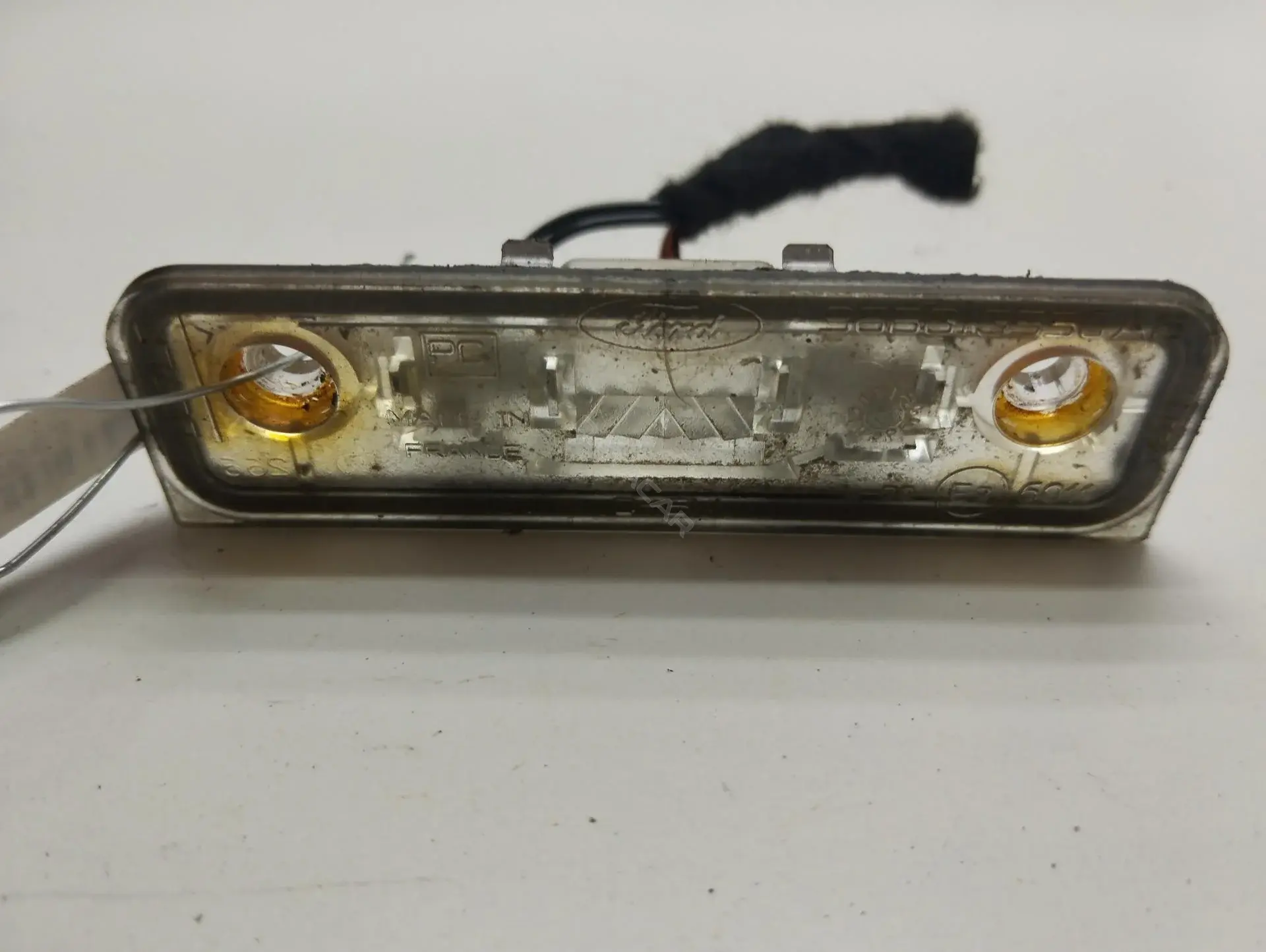 Фонарь подсветки номерного знака 96BG13550AB